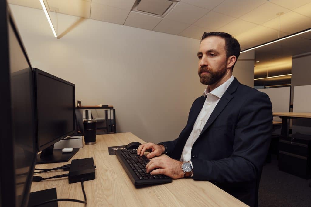 man working on his computer in office